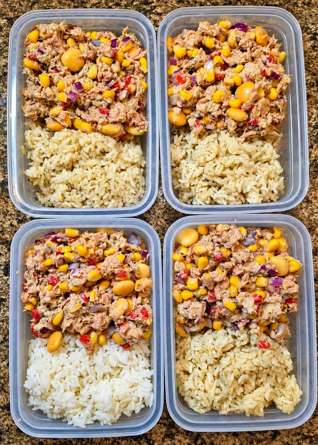 Four portioned tuna and corn salad meals with rice