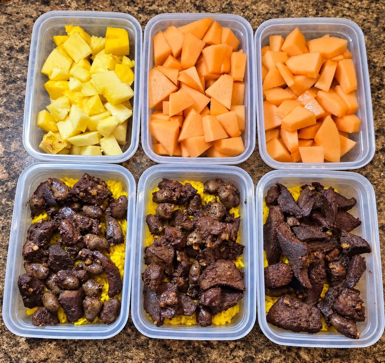 Fresh pineapple and melon above beef over yellow rice