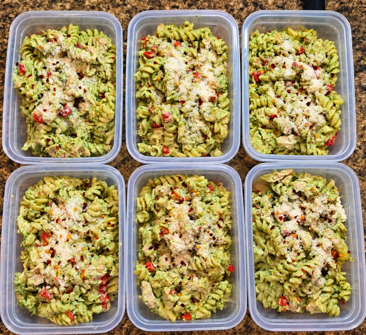 Creamy pesto chicken pasta in meal prep containers