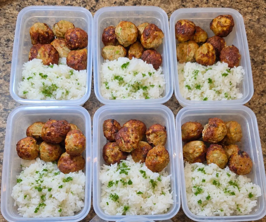 Meatballs with herbed rice portioned into containers
