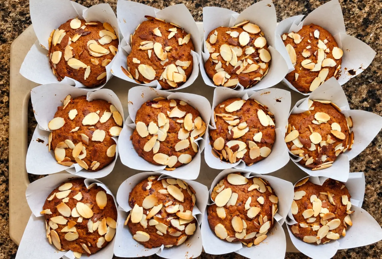 A tray of homemade almond-topped muffins